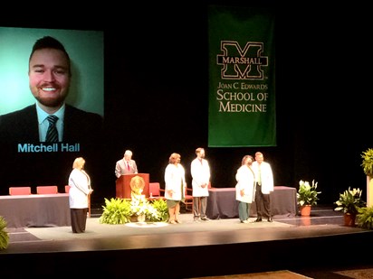 PHOTO:  Huntington native Mitchell Hall receives his white coat during the Marshall University Joan C. Edwards School of Medicine’s second White Coat Ceremony for its Class of 2024 physician assistant (PA) students Saturday, June 4, 2022, at the Joan C. Edwards Performing Arts Center.